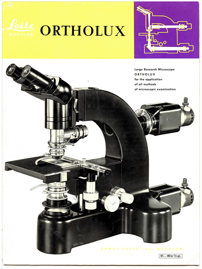 A black microscope with white and purple text
Description automatically generated