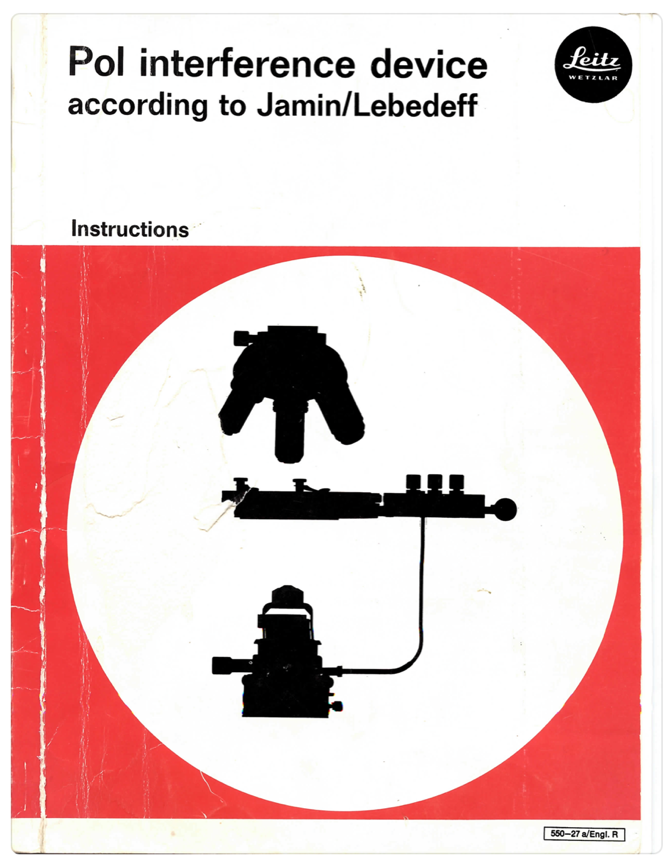 A red and white sign with black silhouettes of a microscope
Description automatically generated