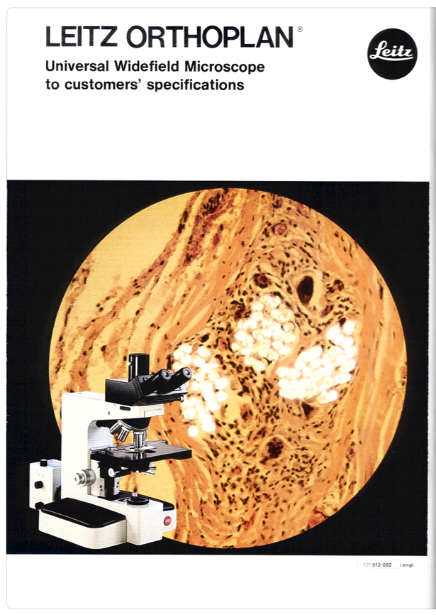 A white and black microscope
Description automatically generated