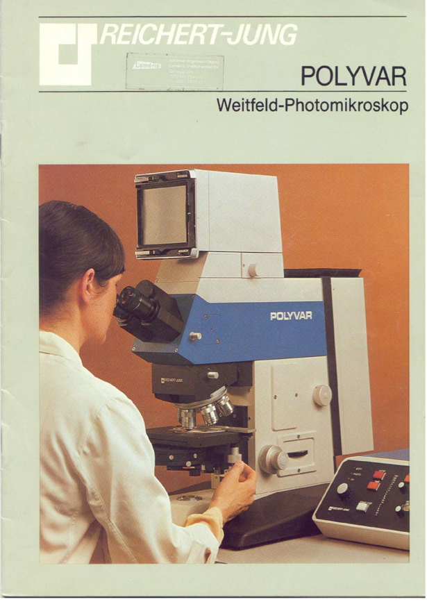 A person looking through a microscope
Description automatically generated