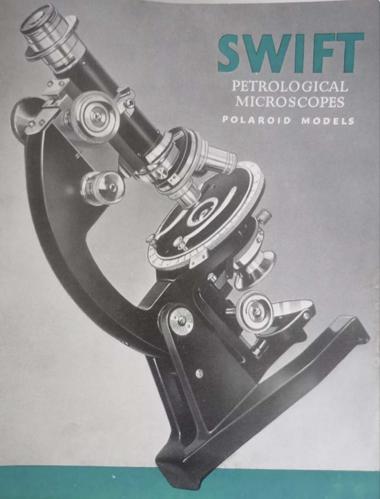 A black and silver microscope
Description automatically generated