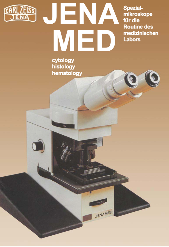 A white microscope with black cover
Description automatically generated