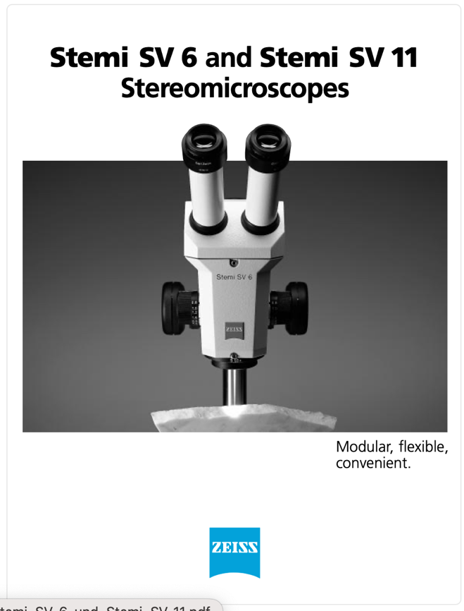A white microscope with black lenses
Description automatically generated