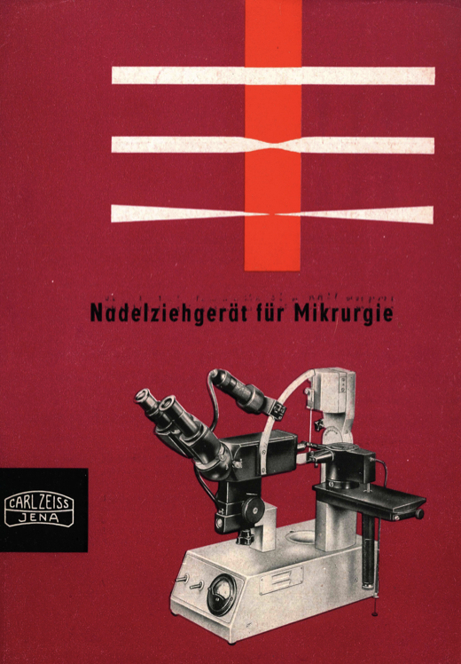 A red cover with a microscope
Description automatically generated