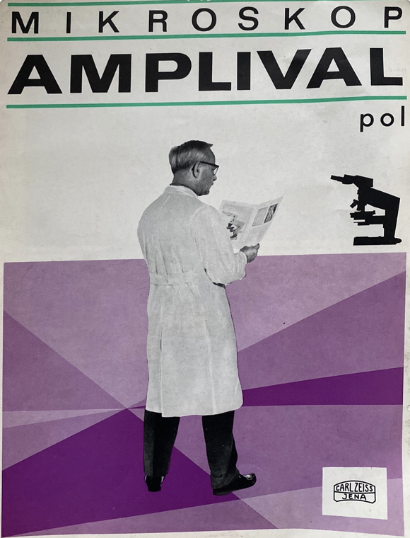 A person in a white coat reading a newspaper
Description automatically generated