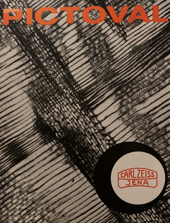 A black and white background with a white circle with a red logo
Description automatically generated