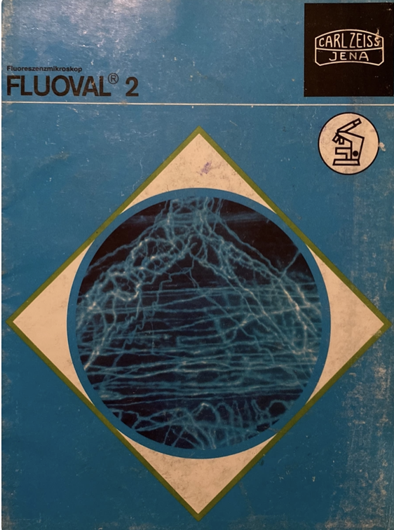 A blue and white cover with a blue circle and a white and green diamond
Description automatically generated