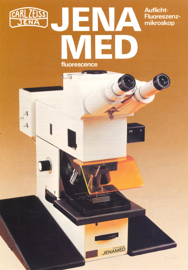 A white microscope with black lenses
Description automatically generated