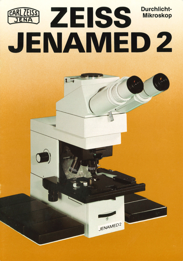 A white and black microscope
Description automatically generated