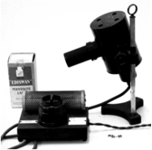 A picture containing cameras & optics, optical instrument, camera, indoor
Description automatically generated