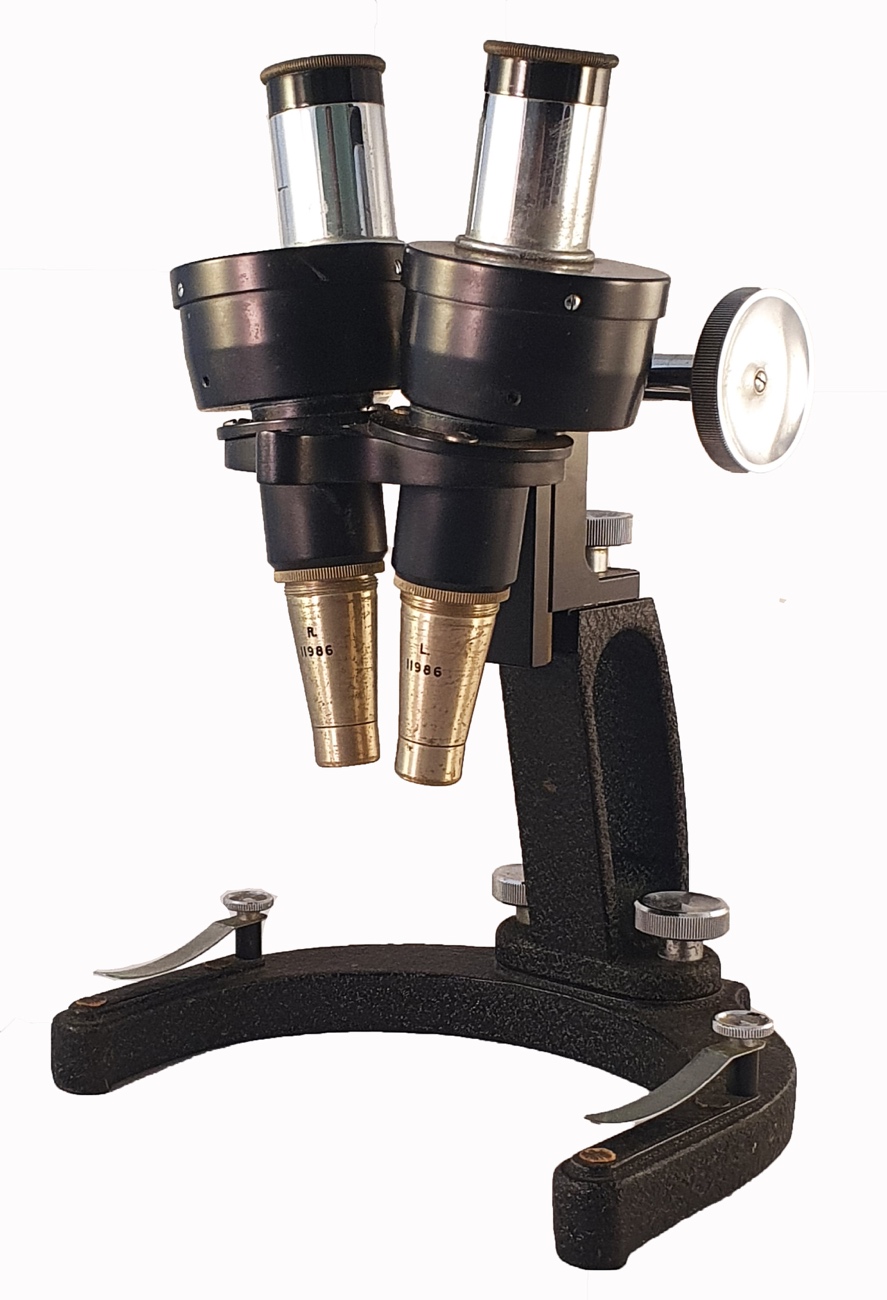 A black microscope with two headsDescription automatically generated