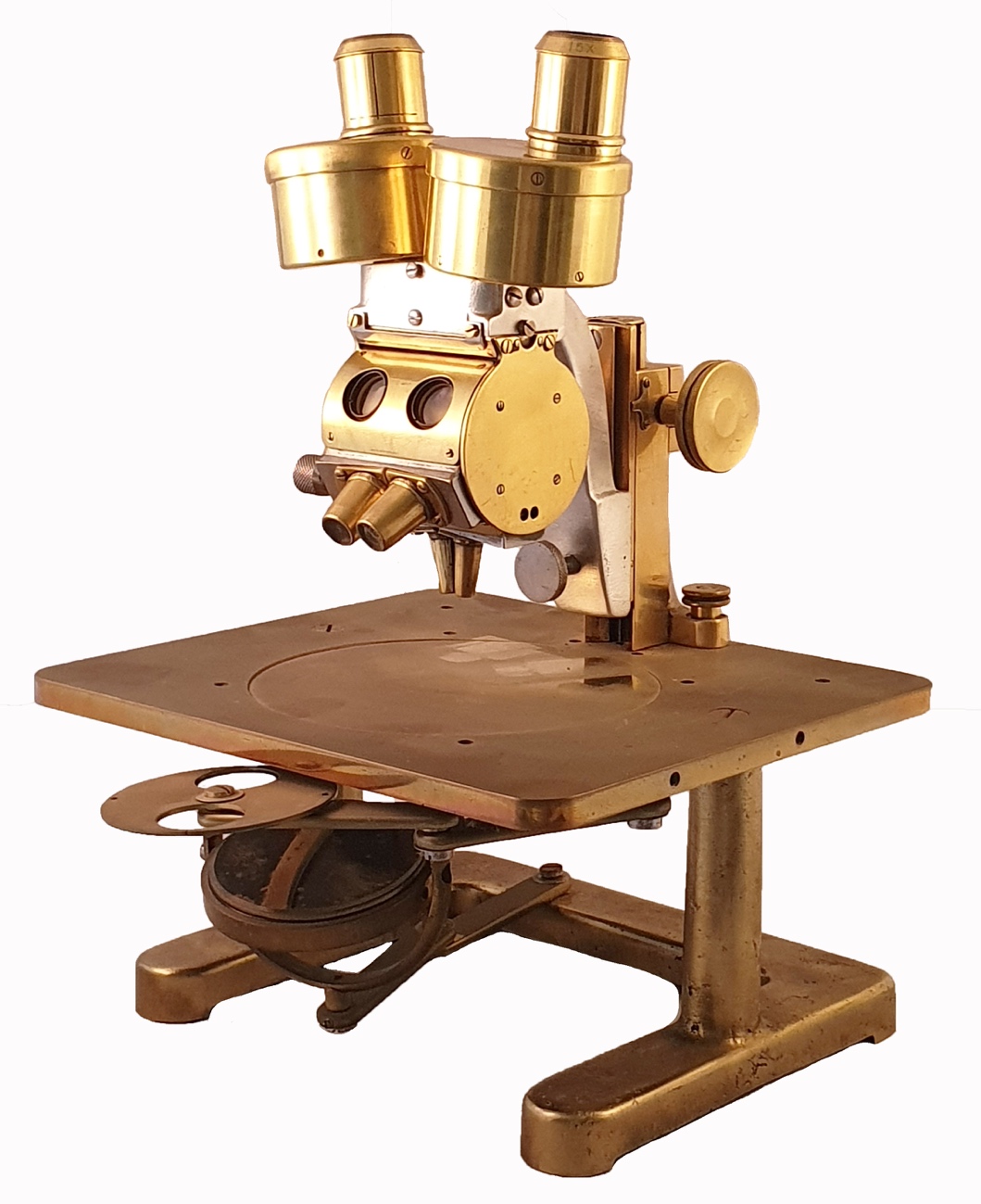 A gold microscope on a white backgroundDescription automatically generated