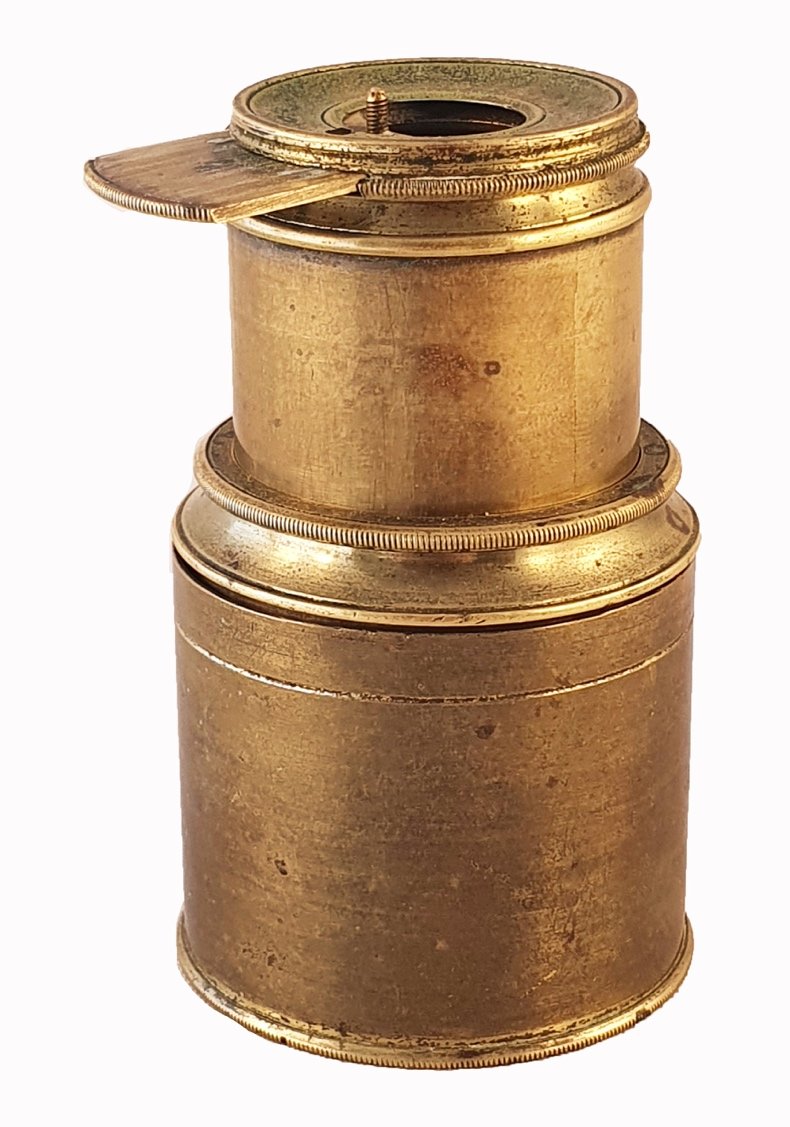 A close-up of a brass cylinderDescription automatically generated