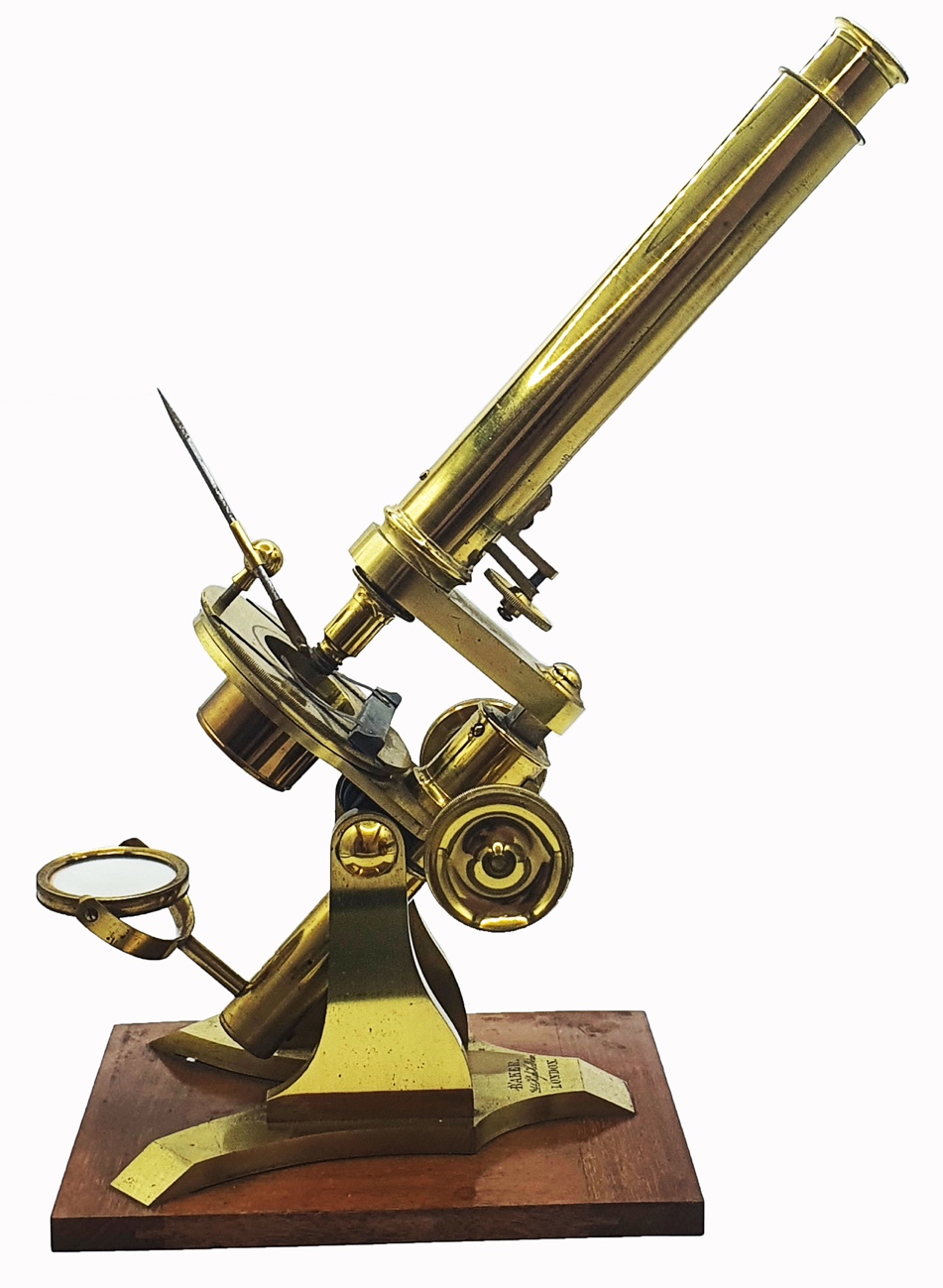 A close-up of a gold microscopeDescription automatically generated