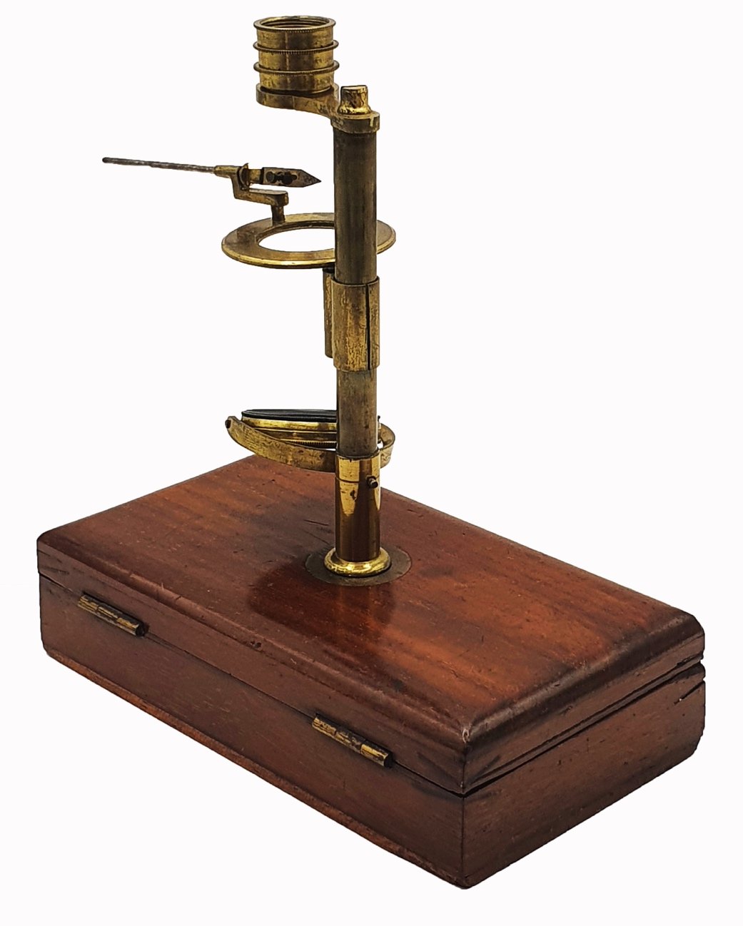 A wooden box with a brass object on itDescription automatically generated