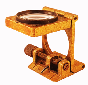 A gold metal device with a magnifying glass
Description automatically generated