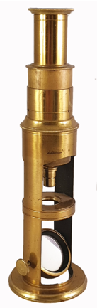 A gold metal object with a hole
Description automatically generated