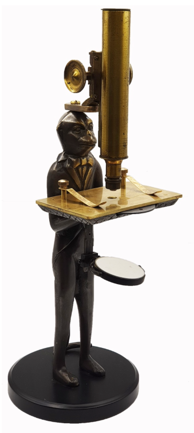 A statue of a cat holding a tray
Description automatically generated